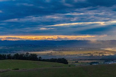 a view of the hills and a beautiful sunset in the countryside