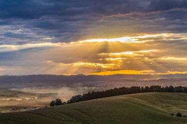 sunset over a rural landscape in the mountains