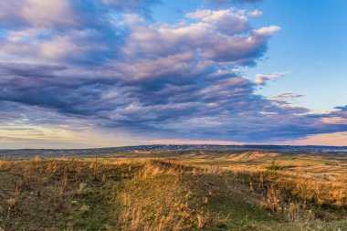 dramatic clouds over the hills