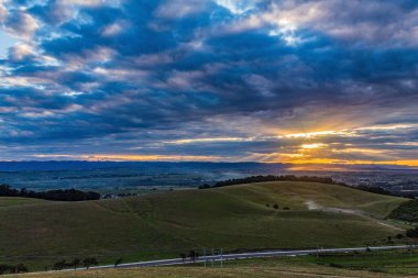 a beautiful shot of a field of grass under the cloudy sky