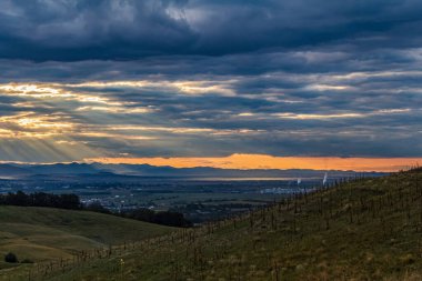sunset at the top of a mountain with a view of the clouds