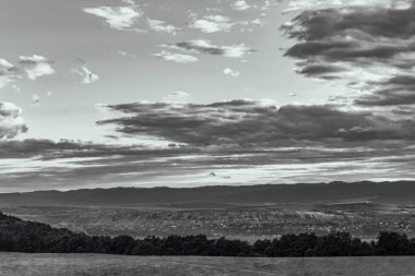 a grayscale shot of a beautiful hills and hills