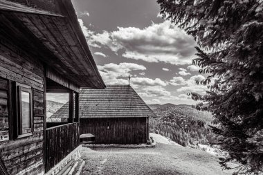 black and white photo of the house in the mountains