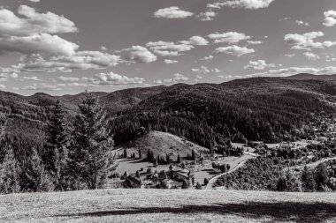 black and white view of the mountains in the summer