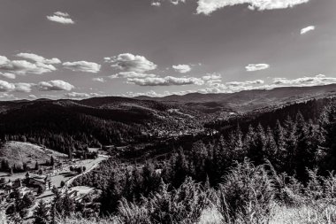 a vertical shot of a beautiful landscape with a road in the middle of a mountain