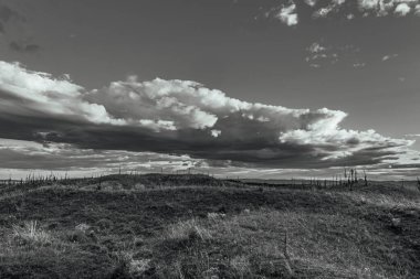 black and white clouds and a beautiful sky with a dark landscape