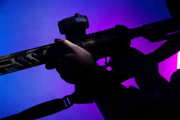 Üniformalı asker. Yüksek kaliteli 4K görüntüler. Tam teçhizatlı kararlı bir asker dumanlı, atmosferik bir sahnede yürüyor. Yoğun ve renkli ışıklandırmayla aydınlatılıyor.. 