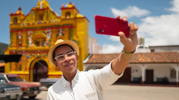 Close-up view of a man in a hat  taking a selfie.