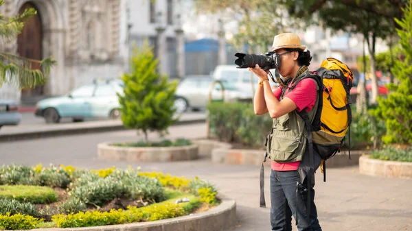Portrait of a photographer taking a photo of the church of San Andrs Xecul Totonicapan.