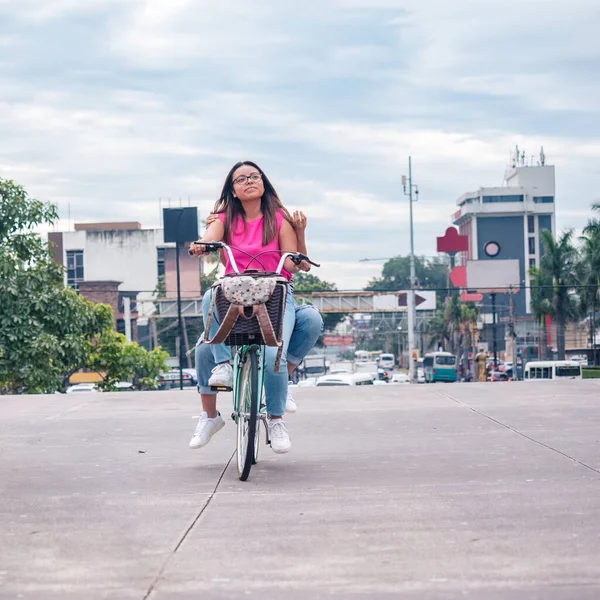 happy best friends cycling on bicycle in city, on vacation in San Salvador.