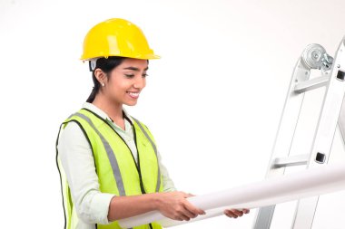 Female architect looking at blueprints,isolated on white background.