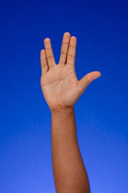 Fingers and palms making signs on a blue background