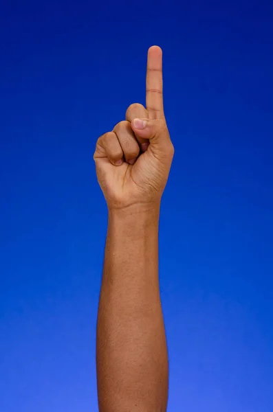 Man raising hand and showing number one with clipping path