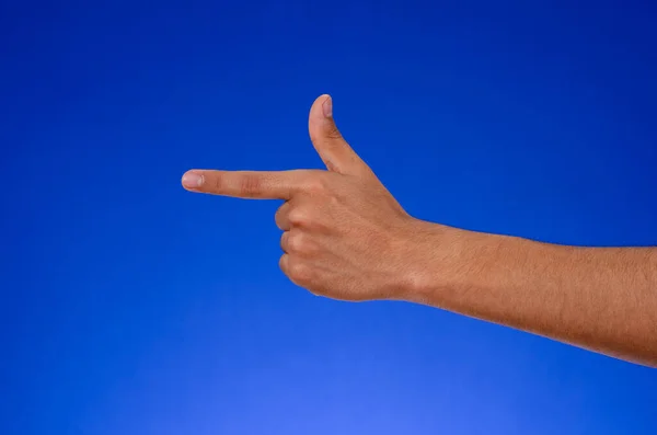 Left hand pointing on blue background