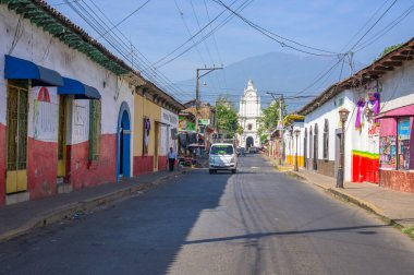 Cityscape in the main street of Izalco city with the Izalco volcano in the background clipart