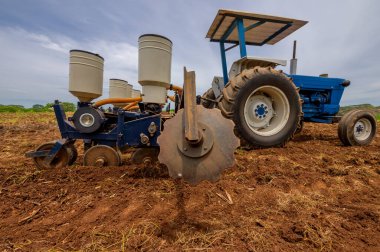 Tractor in the field. Industrial vehicle for working the land.               clipart