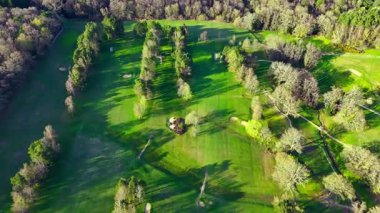 İlkbaharda doğa ve ağaçlarla çevrili İngiliz golf sahası hava aracı üstgeçidi manzarası