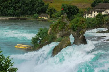 23 Mayıs 2023, İsviçre, Schaffhausen. Ünlü Ren Şelalesi 'nin yanındaki sarı zevk teknesi. Yüksek kalite fotoğraf