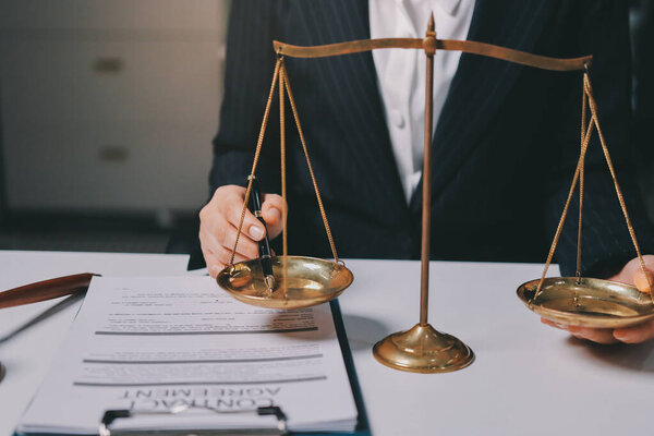 Judge gavel with Justice lawyers having team meeting at law firm background. Concepts of Law and Legal services.