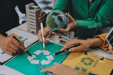 Genç Asyalı iş adamları ofiste yeniden kullanılabilir ürün tartışması, çevre dostu iş kurma, çevre koruma, sürdürülebilir iş modeli, ESG stratejisi, takım toplantısı, ev konseptinde çalışan insanlar