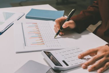 Vergi indirimi konsepti. Kadınlar kişisel gelir vergileri için vergi indirimi almak için harcamaları ve vergileri hesaplamak için bir hesap makinesi kullanıyorlar. Bireyler için vergi beyannamesi. Aylık giderler