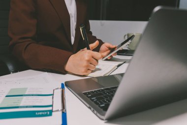 Vergi indirimi konsepti. Kadınlar kişisel gelir vergileri için vergi indirimi almak için harcamaları ve vergileri hesaplamak için bir hesap makinesi kullanıyorlar. Bireyler için vergi beyannamesi. Aylık giderler