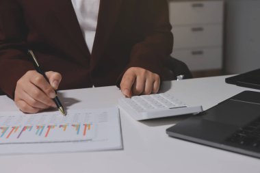 Vergi indirimi konsepti. Kadınlar kişisel gelir vergileri için vergi indirimi almak için harcamaları ve vergileri hesaplamak için bir hesap makinesi kullanıyorlar. Bireyler için vergi beyannamesi. Aylık giderler