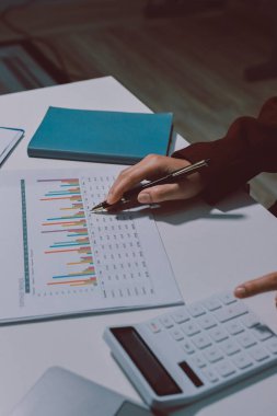 Vergi indirimi konsepti. Kadınlar kişisel gelir vergileri için vergi indirimi almak için harcamaları ve vergileri hesaplamak için bir hesap makinesi kullanıyorlar. Bireyler için vergi beyannamesi. Aylık giderler