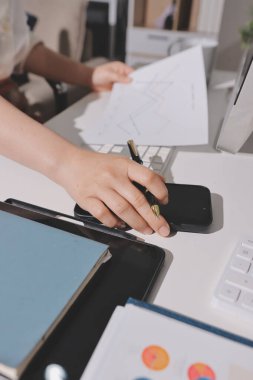 Uzman kadın Asyalı kadınlar idari hesap maliyetli veri numaralarını gözden geçirirler vergi denetleme bürosunda aylık gerçek maliyet varyansı raporu hazırlarlar. ESG tablo bütçe denetimi ERP süreci servis projesi.