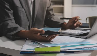 Evden çalışan, iş kadını dizüstü bilgisayar kullanıyor ve mali raporları analiz ediyor..