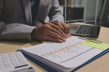 Evden çalışan, iş kadını dizüstü bilgisayar kullanıyor ve mali raporları analiz ediyor..