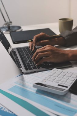 Evden çalışan, iş kadını dizüstü bilgisayar kullanıyor ve mali raporları analiz ediyor..