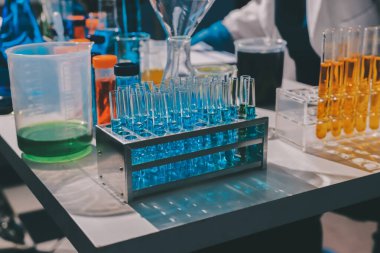 Bilimadamı laboratuarda tıbbi örnekleri mikro plakaya yerleştiriyor.