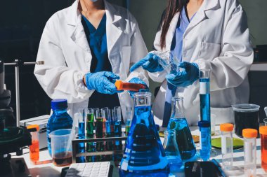 Bilimadamı laboratuarda tıbbi örnekleri mikro plakaya yerleştiriyor.