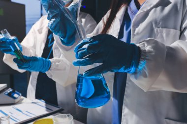 Bilimadamı laboratuarda tıbbi örnekleri mikro plakaya yerleştiriyor.