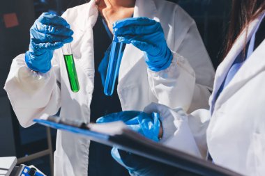 Bilimadamı laboratuarda tıbbi örnekleri mikro plakaya yerleştiriyor.