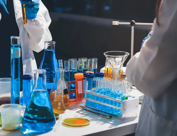 Bilimadamı laboratuarda tıbbi örnekleri mikro plakaya yerleştiriyor.