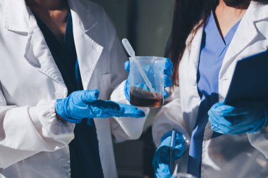 Bilimadamı laboratuarda tıbbi örnekleri mikro plakaya yerleştiriyor.