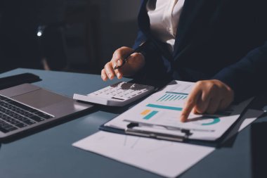 Uzman kadın Asyalı kadınlar idari hesap maliyetli veri numaralarını gözden geçirirler vergi denetleme bürosunda aylık gerçek maliyet varyansı raporu hazırlarlar. ESG tablo bütçe denetimi ERP süreci servis projesi.