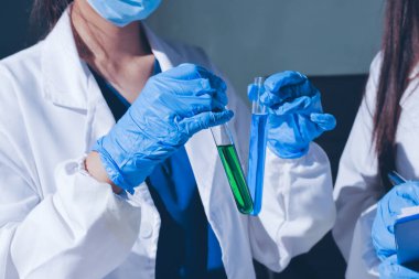 Bilimadamı laboratuarda tıbbi örnekleri mikro plakaya yerleştiriyor.