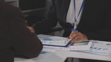 İş adamları toplantıda mali tabloları ve grafikleri tartışıyor