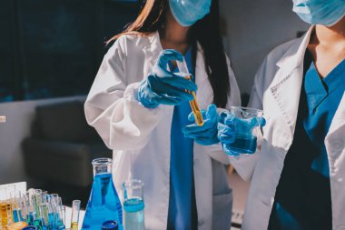 Bilimadamı laboratuarda tıbbi örnekleri mikro plakaya yerleştiriyor.