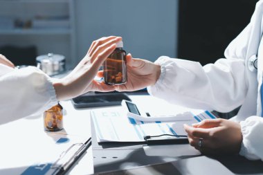 Erkek ve kadın doktorlar bir hastane odasında toplantı yapıyorlar..