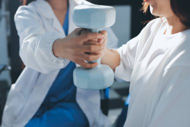 Tanımlanamayan fiziksel terapi sırasında mavi el ağırlığı kullanır