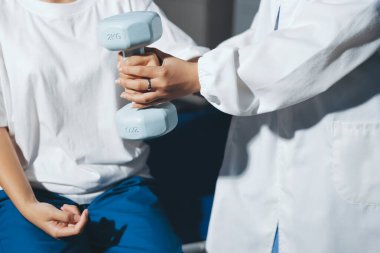 Tanımlanamayan fiziksel terapi sırasında mavi el ağırlığı kullanır