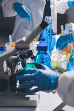 Bilimadamı laboratuarda tıbbi örnekleri mikro plakaya yerleştiriyor.