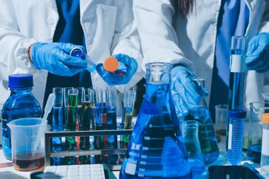 Bilimadamı laboratuarda tıbbi örnekleri mikro plakaya yerleştiriyor.