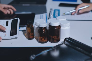 Erkek ve kadın doktorlar bir hastane odasında toplantı yapıyorlar..