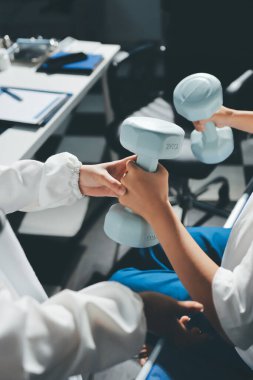 Tanımlanamayan fiziksel terapi sırasında mavi el ağırlığı kullanır