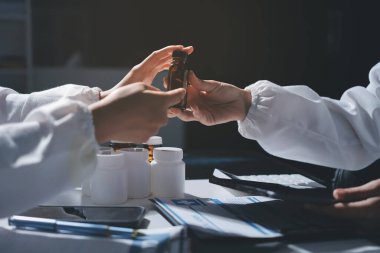 Erkek ve kadın doktorlar bir hastane odasında toplantı yapıyorlar..